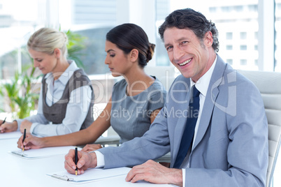 Group of business people taking notes