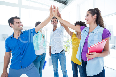 Young business people putting their hands together