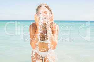 Pretty blonde watering her face