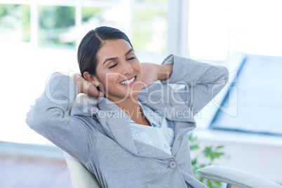 Businesswoman relaxing in a swivel chair