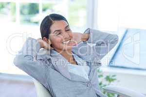 Businesswoman relaxing in a swivel chair