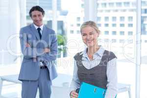 Smiling business people looking at camera