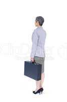 Side view of businesswoman stranding with suitcase