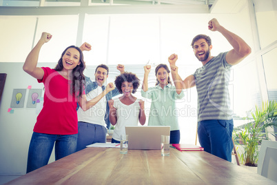 Happy business team with fists in the air