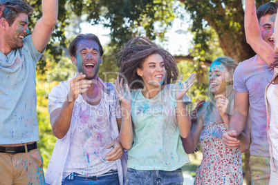 Happy friends covered in powder paint