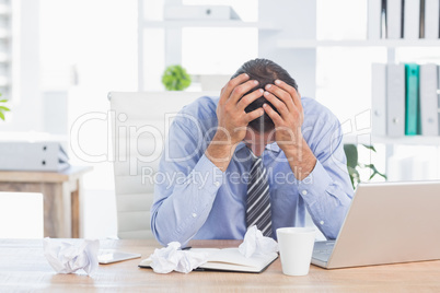 Frustrated businessman working in his office