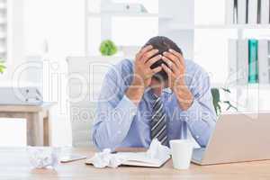 Frustrated businessman working in his office