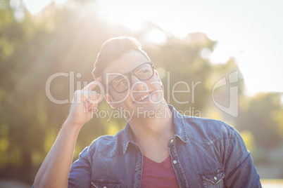 Handsome thinking hipster in the park