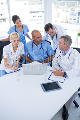 Team of doctors discussing during meeting Team of doctors discussing during meeting