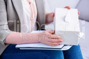 Businesswoman holding paper tissue box
