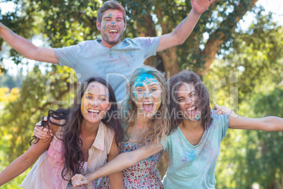 Happy friends covered in powder paint