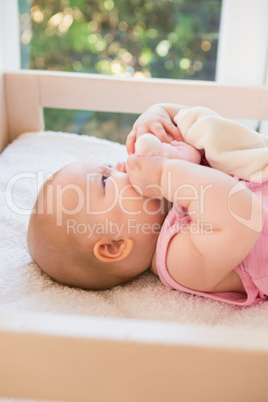 Beautiful cute baby girl in her bed