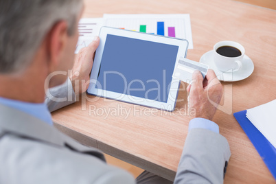 businessman holding tablet and credit card