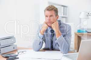 Worried businessman sitting at work