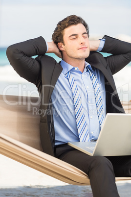 Businessman relaxing on hammock