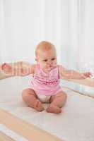 Beautiful cute baby girl in her bed