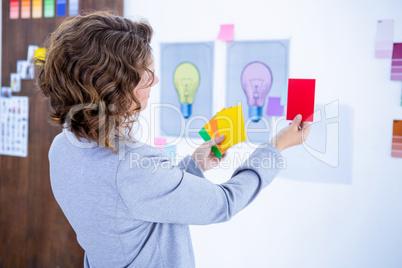 Creative businesswoman holding color cards