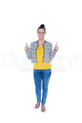 Happy brunette looking at camera with thumbs up