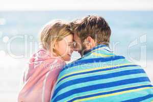 Happy couple relaxing together in the sand