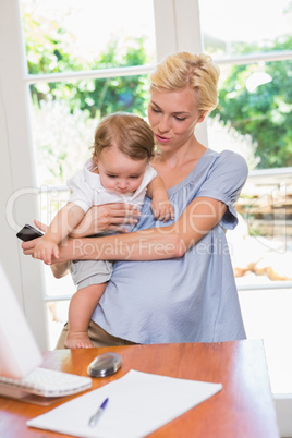 Blonde woman with his son using laptop