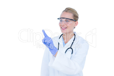 Blonde doctor with hands raised and wearing protective glasses