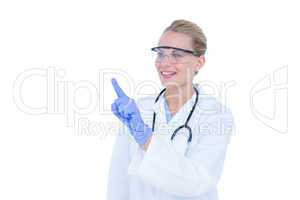 Blonde doctor with hands raised and wearing protective glasses