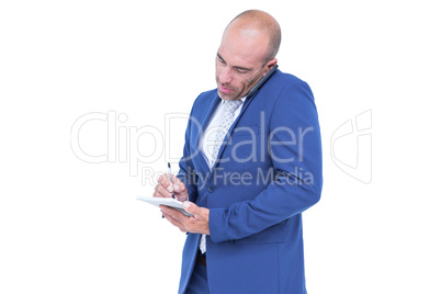 Young businessman writing on a notepad