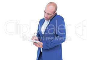 Young businessman writing on a notepad