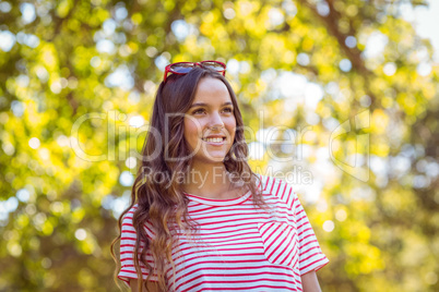 Pretty brunette smiling in the park