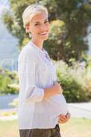 Portrait blonde smiling pregnant hand on his belly