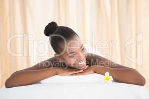 Peaceful smiling pretty woman lying on towel