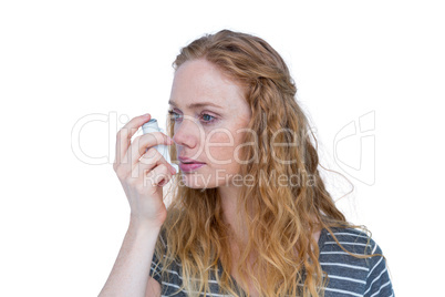 Pretty blonde using an asthma inhaler