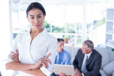 Beautiful businesswoman with arms crossed at office
