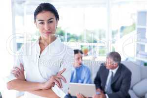 Beautiful businesswoman with arms crossed at office