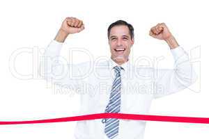 Happy businessman cutting red ribbon