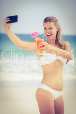 Pretty girl in swimsuit taking a selfie