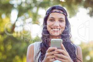 Pretty hipster using her smartphone