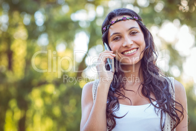 Pretty hipster on the phone in the park