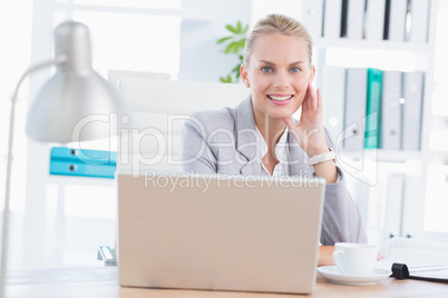 Smiling businesswoman using her computer