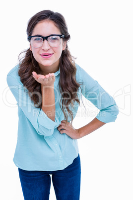 Pretty geeky hipster sending kiss to camera