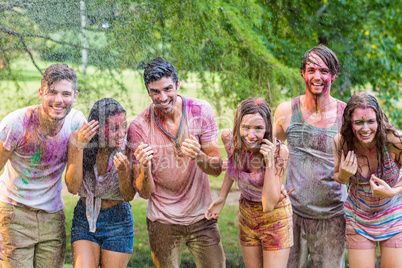 Happy friends covered in powder paint