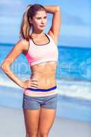 Fit woman standing beside the sea