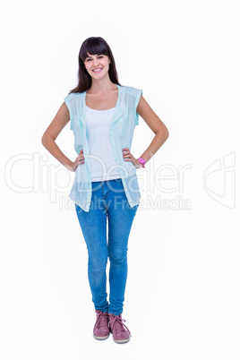 Pretty hipster with hands on hips smiling at camera