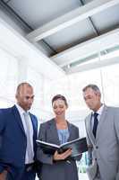 Businesswoman showing her notes to her colleagues