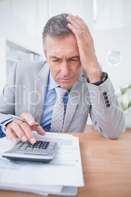Businessman using calculator to calculate finance