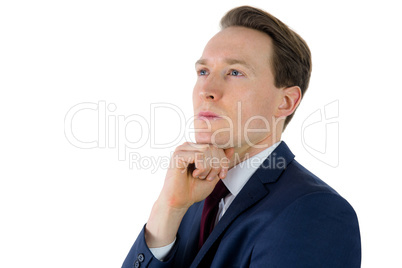 Thoughtful businessman looking away with hand on chin