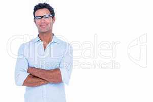 Handsome man with glasses looking at camera with arms crossed