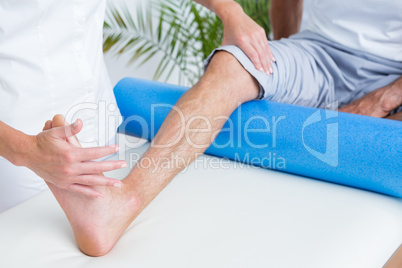 Doctor examining her patient leg