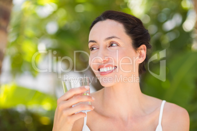 woman in white having a glass of water