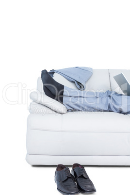 Businessman lying on couch legs only visible